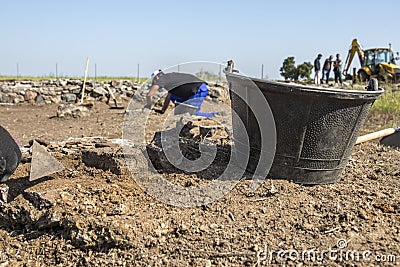 Specialized workers digging with trowel on archaeological excavation Stock Photo