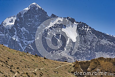 Specific Himalayan Karakoram landscape with deep valleys, arid landscape and peaks over 7000 and 8000m full of snow with walls sti Stock Photo