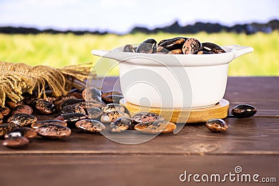 Speckled colored butter beans painted lady scarlet runner with field behind Stock Photo