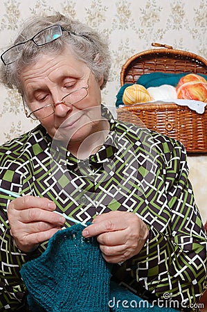 Spectacled grandmother to crochet cardigan Stock Photo