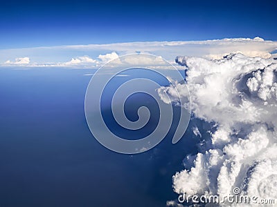 Spectacular aerial view from airplane window, beautiful, unique and picturesque white clouds with deep blue sky background Stock Photo