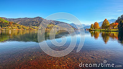 Spectacular autumn view of lake and trees in city park of Sell Am See Stock Photo