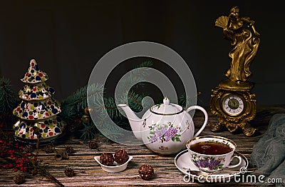 Spectacular Christmas teapot and tea cup, sweets in a ceramic plate, Christmas tree branches, ceramic Christmas tree and an Stock Photo