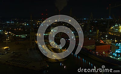 Spectacular night panorama the Remontova shipyard with submarine in to dry dock. Poland, Gdansk, drone footage, Editorial Stock Photo