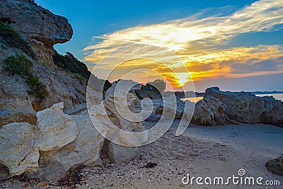 Rocky sandy Chalkidiki beach Greece at sunset Stock Photo
