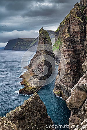 Spectacular steep coast of Faroe Islands, vertical composition Stock Photo