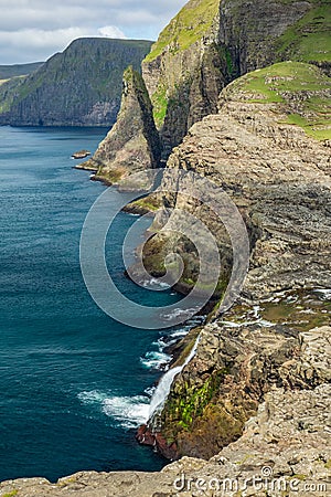 Spectacular steep coastline with high cliffs of faroe islands Stock Photo