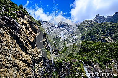 Spectacular waterfall in Milford Sound fiord. Stock Photo