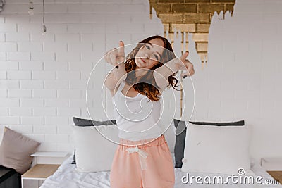 Spectacular woman in sleepwear enjoying morning photoshoot in her stylish room. Indoor shot of inte Stock Photo
