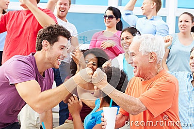 Spectators Cheering At Outdoor Sports Event Stock Photo