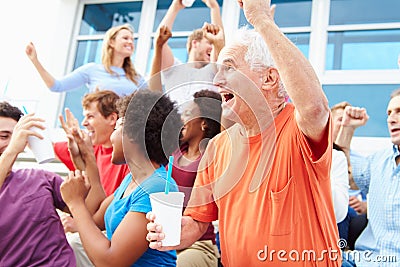 Spectators Cheering At Outdoor Sports Event Stock Photo