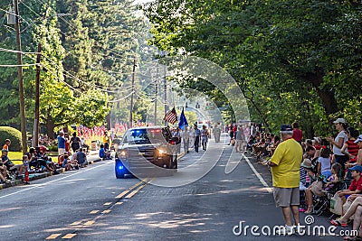 Spectators and Police Leading Parade Editorial Stock Photo
