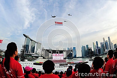 Spectators standing at attention as the national flag flypast during National Day Parade (NDP) Rehearsal 2013 Editorial Stock Photo