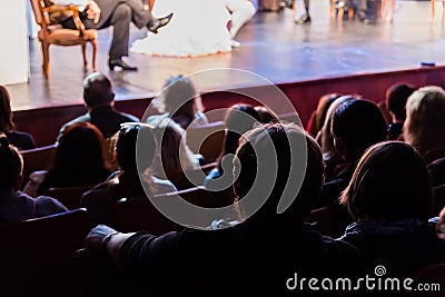 Spectators at a theater performance, in a cinema or at a concert. Shooting from behind. The audience in the hall Editorial Stock Photo