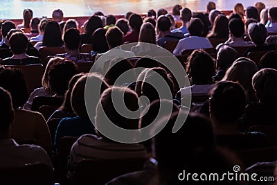 Spectators at a theater performance, in a cinema or at a concert. Shooting from behind. The audience in the hall Editorial Stock Photo