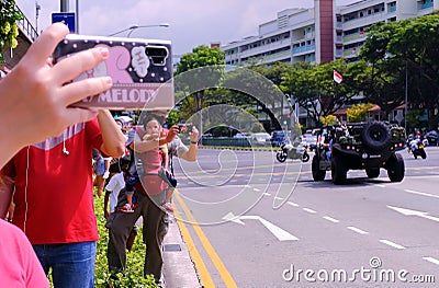 Spectators waiting for Singapore Mobile Column military parade on National Day Editorial Stock Photo