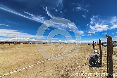 Spectators watching natives play football soccer in a barren field Editorial Stock Photo