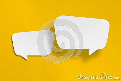 Speech balloon shape white paper isolated on yellow background Stock Photo