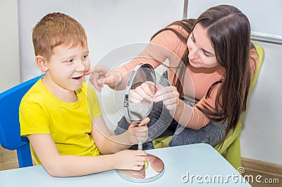 Speech-language pathology concept. Woman and boy Stock Photo