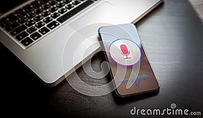 Speech recognition concept - close-up mobile phone with microphone icon and wave sound symbol. Personal voice assistant siri Stock Photo