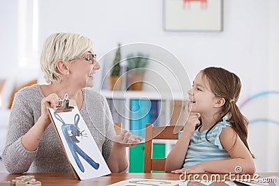 Speech specialist and happy girl Stock Photo