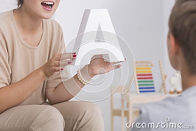 Speech therapist in beige costume Stock Photo