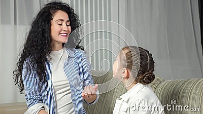 Speech therapist helps girl kid make correct sound at home Stock Photo