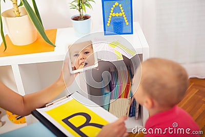 Speech therapist teaches the boys to say the letter R Stock Photo