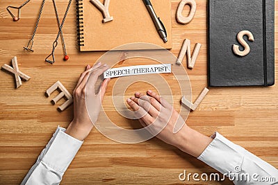 Speech therapist at wooden table, top view Stock Photo