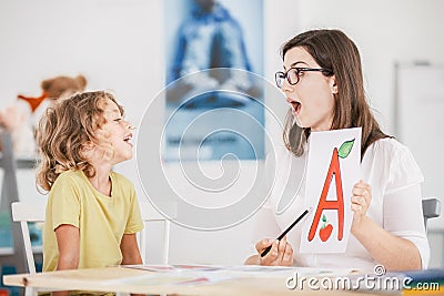 Speech therapist working with a child on a correct pronunciation Stock Photo
