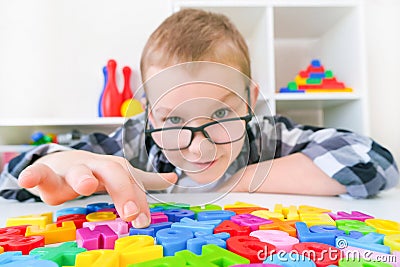 Speech therapy. Toddler boy with letters Stock Photo