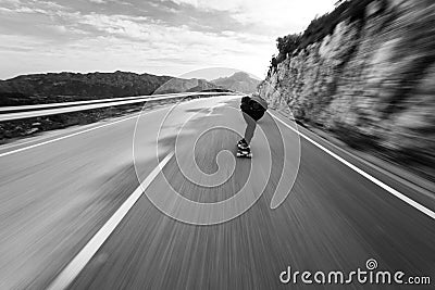 Speed blur fast longboard downhill Stock Photo