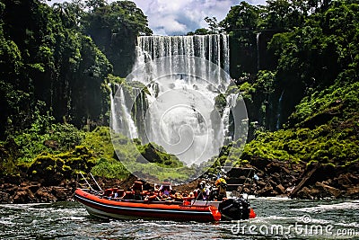 Speed boat rides under the water cascading over the Iguacu falls in Iguacu, Brazil Editorial Stock Photo