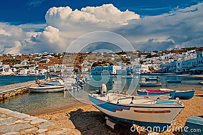 Speed boats on sea beach in Mykonos, Greece. Sea village with white houses on mountain landscape. Summer vacation on Editorial Stock Photo