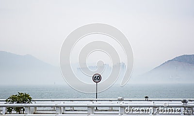 Speed limitation board in front of sea Stock Photo