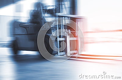 Speed Motion Blur of Forklift Tractor Driving Load at The Warehouse. Stock Photo
