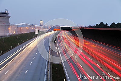 Speed Traffic at Dramatic Sundown Time - light trails on motorway highway at night, long exposure abstract urban background Stock Photo