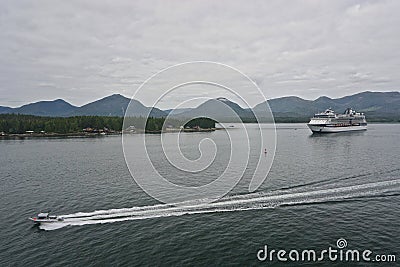 A speedboat races past a cruise ship in the Tongass Narrows Editorial Stock Photo