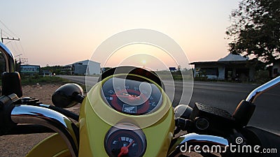Speedometer on a yellow scooter at sunset in Krabi, Thailand Editorial Stock Photo