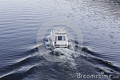Speedy luxury white motor boat on the water surface Stock Photo