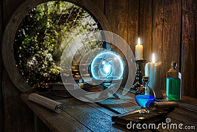 Spell book, Crystal mystic light ball, magic ring, magic potions bottles, burning candle and other various witchcraft accessories Stock Photo