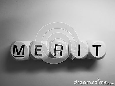 Word merit spelled on wooden dice Stock Photo