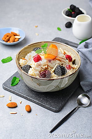 Spelt Porridge with Fruits, Berries, and Nut Topping, Healthy Breakfast or Snack Stock Photo