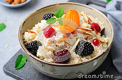 Spelt Porridge with Fruits, Berries, and Nut Topping, Healthy Breakfast or Snack Stock Photo