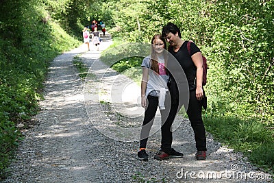 Spending great time together on macadam road through the forest Stock Photo