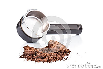 Spent or used coffee grounds with portafilter at the background Stock Photo
