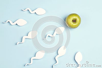 Sperm cells moving towards the green apple egg Stock Photo