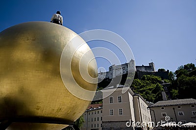 Sphaera, statue of a man on a golden globe on the Kapitelplatz i Editorial Stock Photo