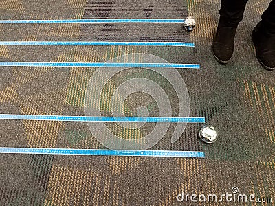 Sphere robots and blue tape on carpet or rug Stock Photo