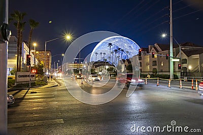 The Sphere at The Venetian Resort with lush green palm trees and cars driving on the street at night in Las Vegas Nevada Editorial Stock Photo